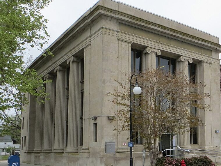 A columned stone bank building on a corner