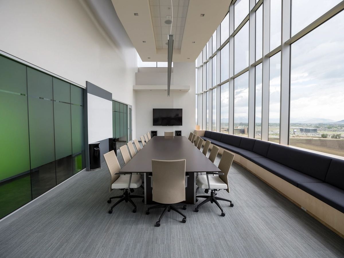 An empty board room with a long table